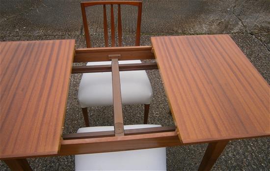 A Gordon Russell teak extending dining table and six chairs (4+2 carvers)